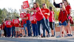 Teachers at Humphrey Elementary school participate in a state-wide walk-in prior to classes Wednesday, April 11, 2018, in Chandler, Ariz. Arizona teachers are demanding a 20 percent pay raise and more than $1 billion in new education funding. (AP Photo/Matt York)
