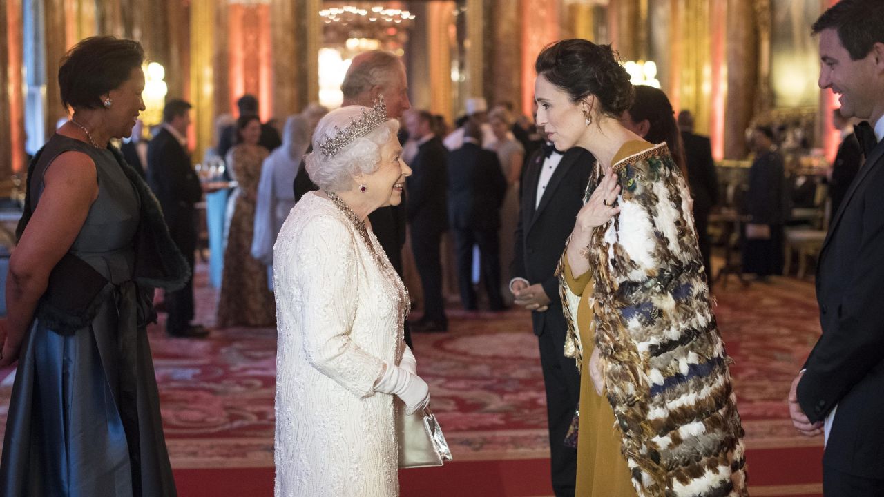 Queen Elizabeth II greets Jacinda Ardern in the Blue Drawing Room at The Queen's Dinner on April 19 in London.