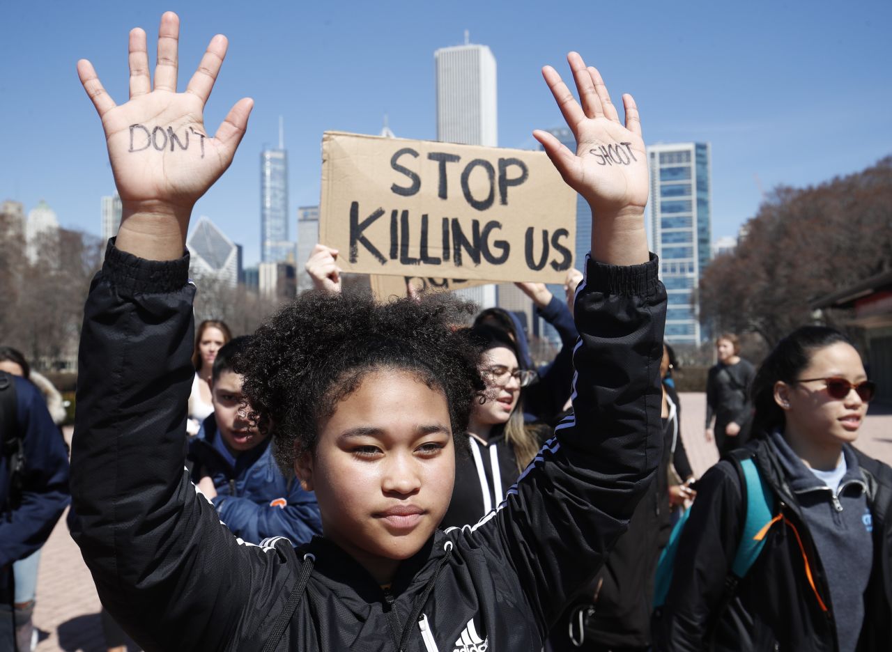 A student holds up her hands while taking part in National School Walkout Day to protest school violence Friday, April 20, in Chicago. Students from around the nation joined in the walkout against gun violence on the 19th anniversary of the shooting at Columbine High School.