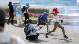 Masked protesters fire from a homemade mortars at riot police as another winds up to throw a rock during a third day of violent clashes in Managua, Nicaragua, Friday, April 20, 2018. The clashes, pitting protesters opposed to social security reforms against riot police and pro-government groups, have rocked the capital, and a half-dozen other cities over the last three days. The Organization of American States have expressed concern over the heavy-handed crackdown, while also calling on demonstrators to protest peacefully. (AP Photo/Alfredo Zuniga)