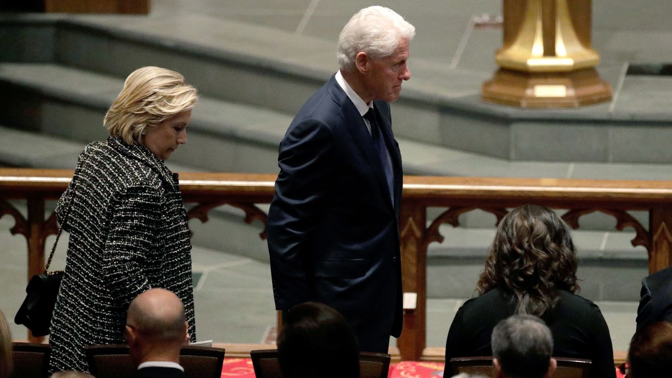 Accompanied by his wife, Hillary Clinton, left, former President Bill Clinton arrives at St. Martin's Episcopal Church. 