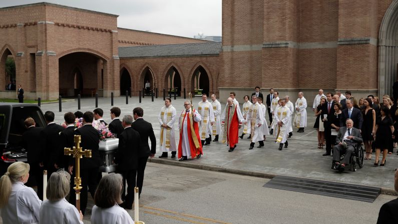 Former Presidents George H.W. Bush and George W. Bush, right, accompanied by their family members, watch as pallbearers carry the casket of former first lady Barbara Bush after her funeral service at St. Martin's Episcopal Church. 