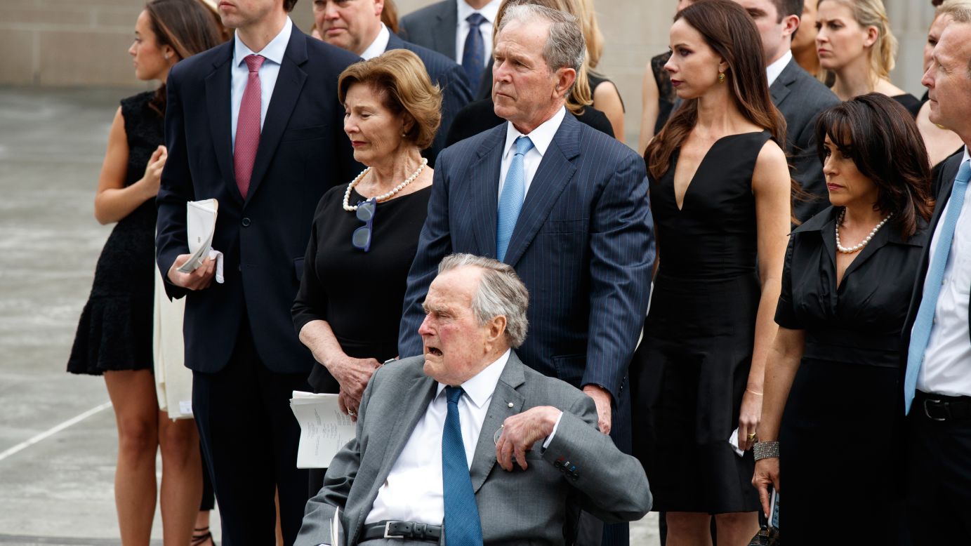 Former President George W. Bush and his father, former President George H.W. Bush, watch as the casket of former first lady Barbara Bush is loaded into a hearse at St. Martin's Episcopal Church.