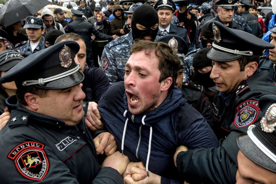 Armenian policemen detain a protester during a rally in central Yerevan on April 21.