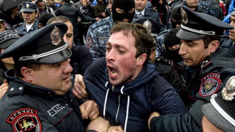 Armenian policemen detain a protester during a rally in central Yerevan on April 21.