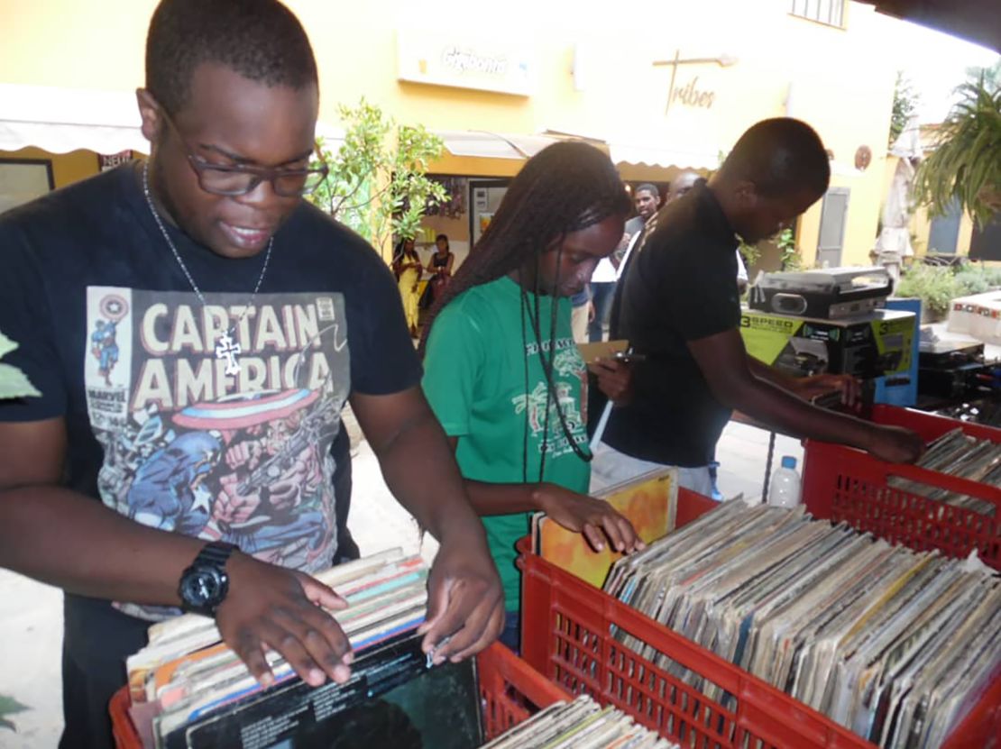 Record collectors digging for vinyl in The Time Machine Zambia, a pop up vinyl store in the capital of Zambia, Lusaka.