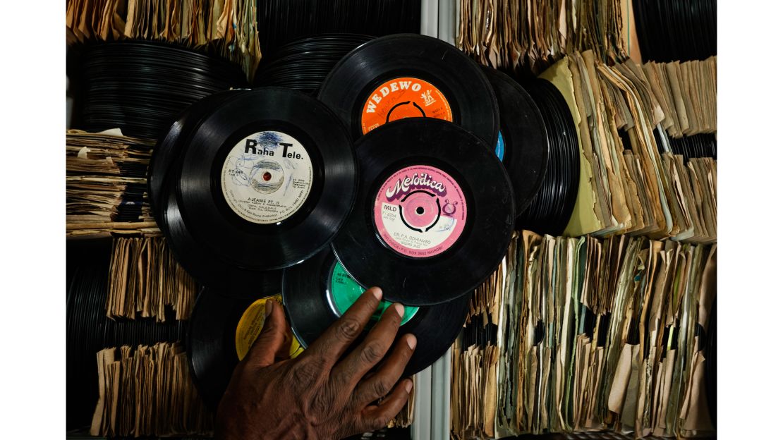 James "Jimmy" Rugami sorts through records inside his vinyl records stall in Kenyatta Market.