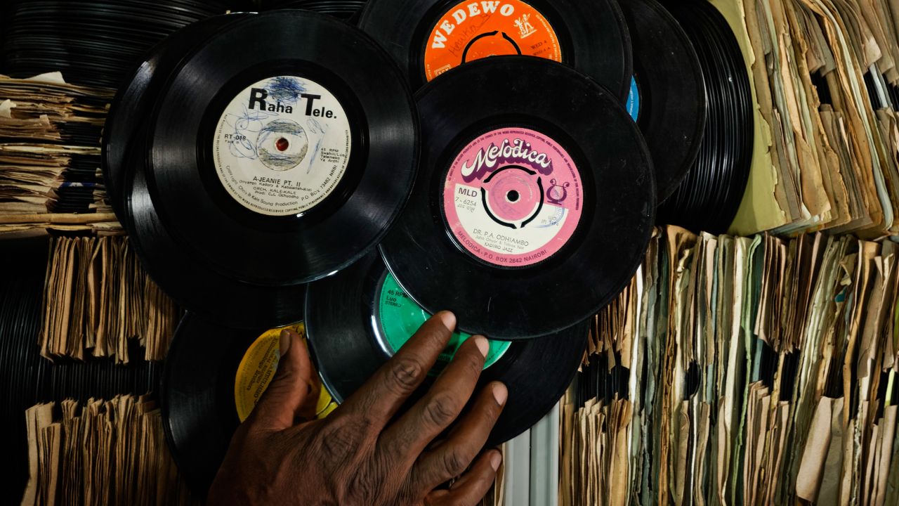 James "Jimmy" Rugami sorts through records inside his vinyl records stall in Kenyatta Market.