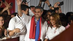 Paraguay's new President and presidential candidate of the Colorado Party, Mario Abdo Benitez (C), next to his wife Silvana Lopez Moreira, cheer at the crowd at Partido Colorado headquarters in Asuncion on April 22, 2018 - Mario Abdo Benitez, who represents Paraguay's long-dominant Colorado conservatives, won Sunday's presidential poll, landing the top job in one of Latin America's poorest countries, election officials said. (Photo by EITAN ABRAMOVICH / AFP)        (Photo credit should read EITAN ABRAMOVICH/AFP/Getty Images)