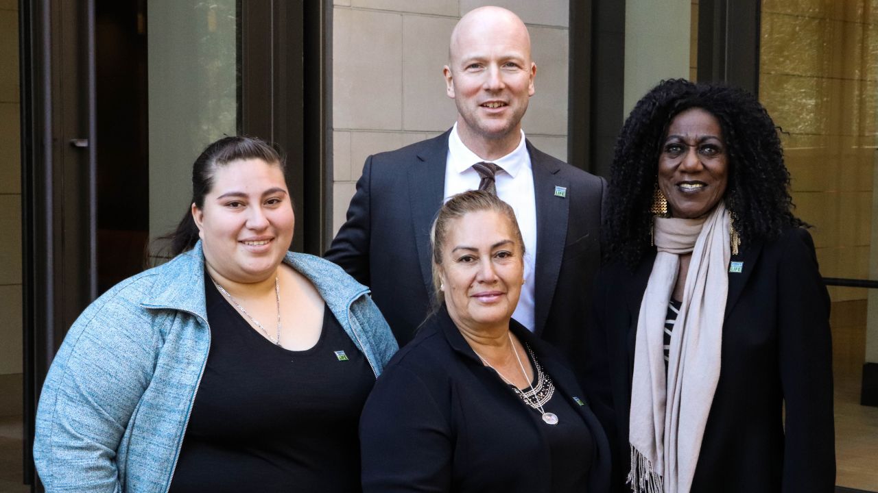 Dr. Jeffrey Veale with the sister and mother of Beto Maldonado, left and center, and Vertis Boyce, right.
