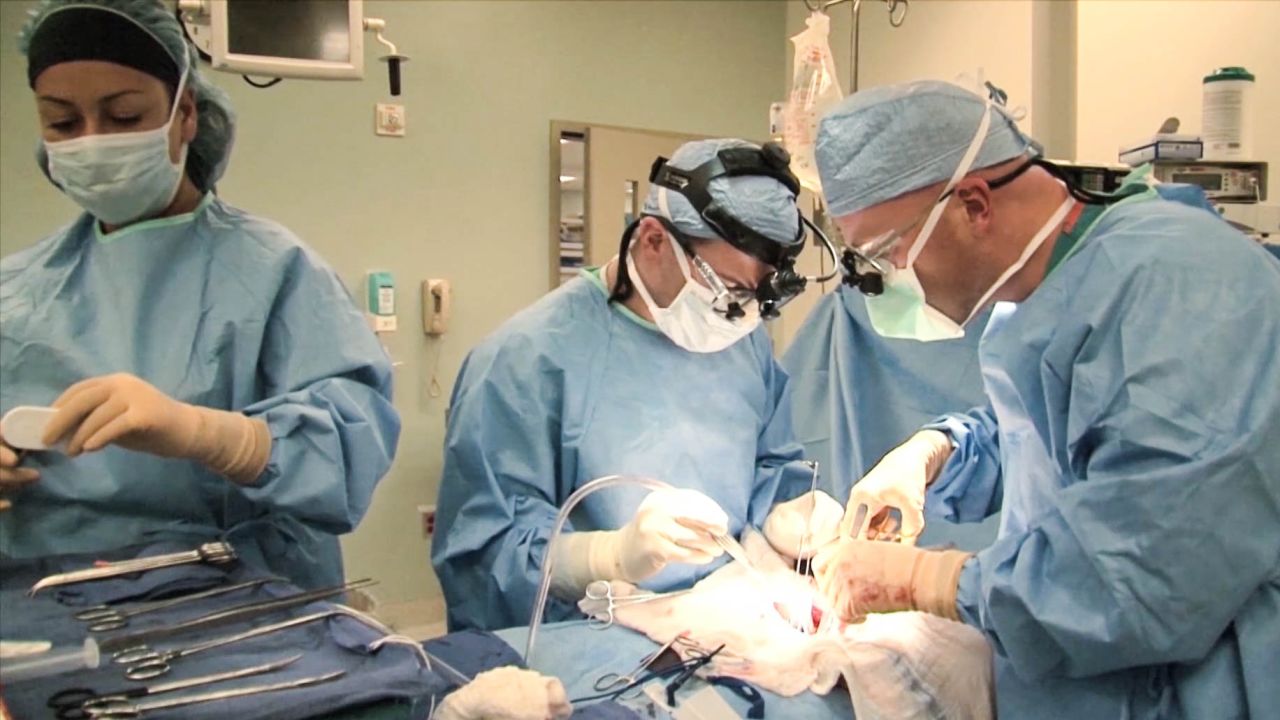 Dr. Jeffrey Veale, right, in the operating room at Reagan UCLA Medical Center.