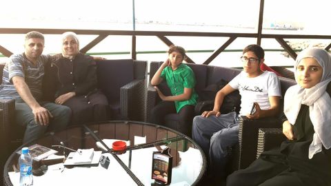 Abdo Elfgeeh and his wife, left, sit with three of their four children.