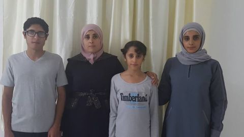 Abdo Elfgeeh's wife, second from left, stands with three of their four children.