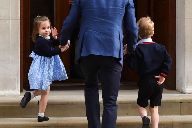 Charlotte turns to wave at journalists as she arrives with her father and her brother George to meet the <a href="index.php?page=&url=https%3A%2F%2Fedition.cnn.com%2Finteractive%2F2018%2F04%2Fworld%2Froyal-baby-cnnphotos%2Findex.html" target="_blank">newest member of their family</a>, her brother Prince Louis, in April 2018. 