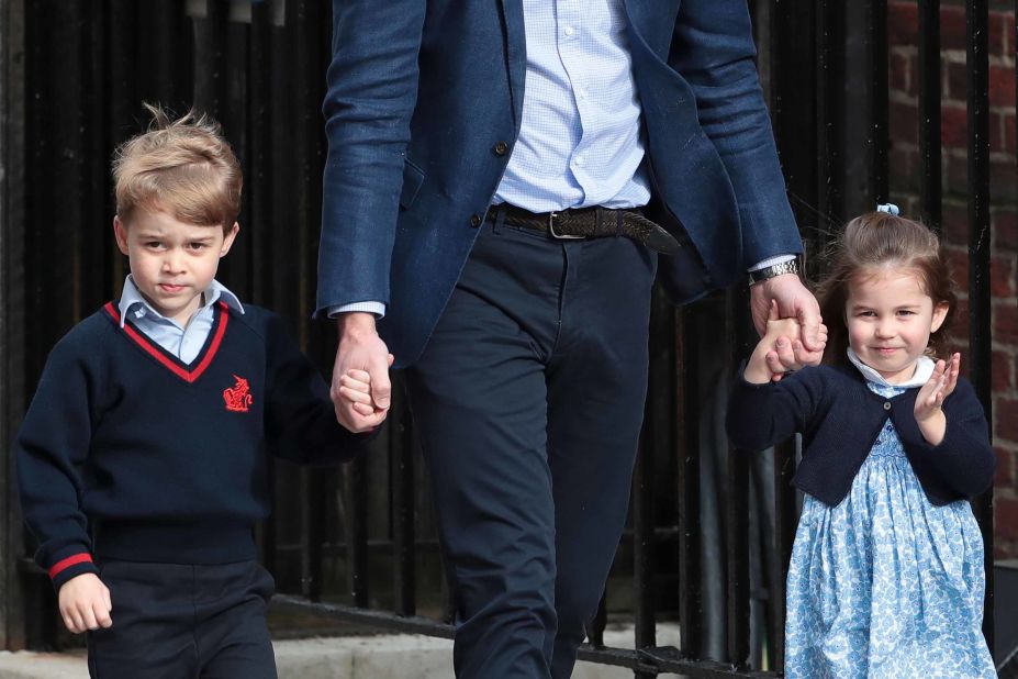 Prince William holds the hands of George and Charlotte as they visit the hospital to meet their new brother.