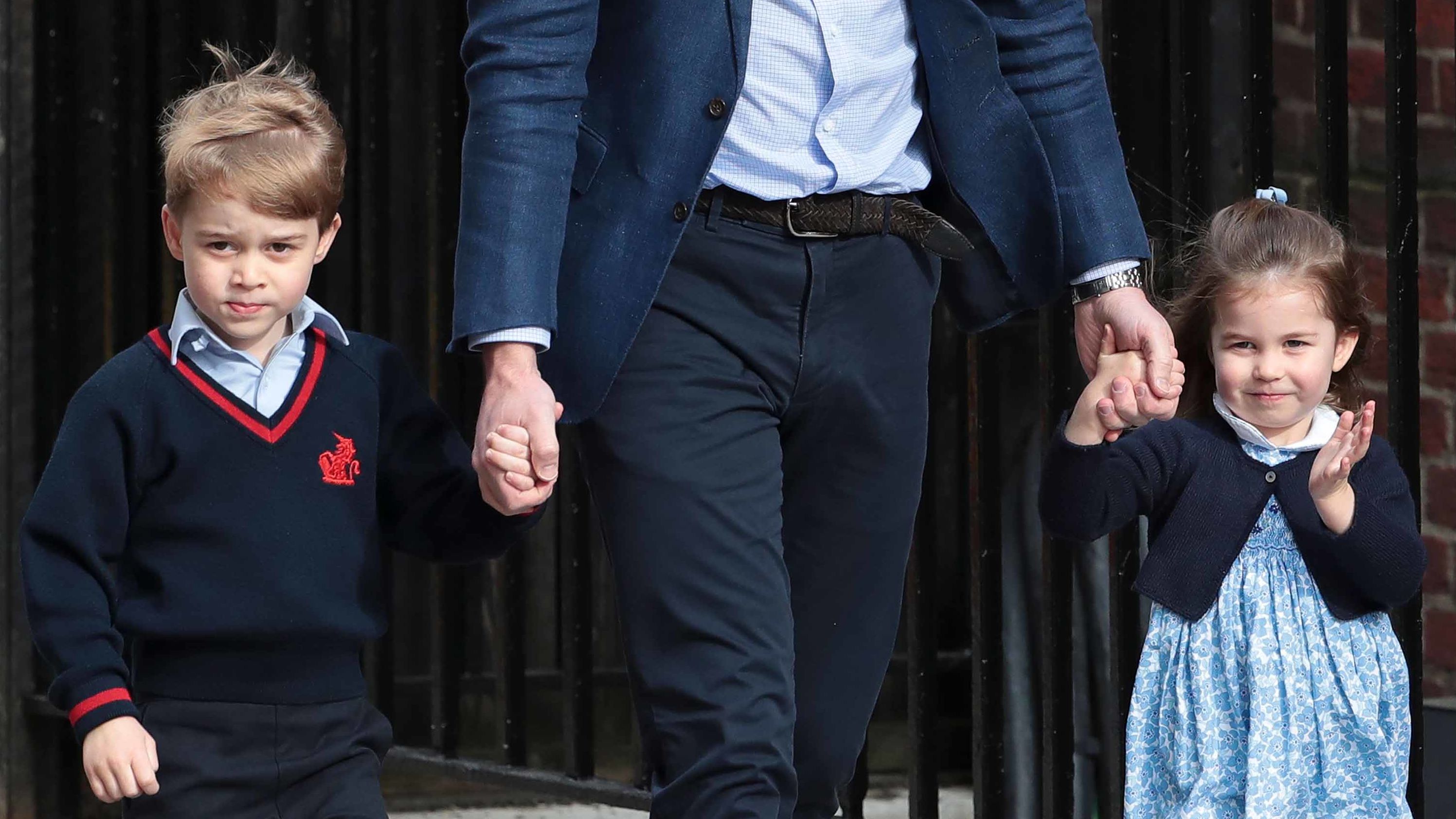 Prince William holds the hands of George and Charlotte as they visit the hospital to meet their new brother.