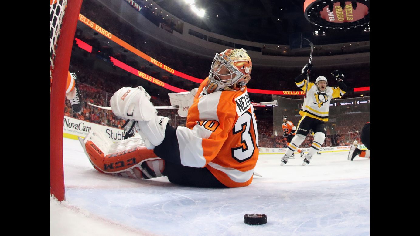 Philadelphia goalie Michal Neuvirth watches the puck behind him as Pittsburgh's Sidney Crosby, not pictured, scores a goal in Game 6 of their first-round playoff series on Sunday, April 22. Jake Guentzel, right, <a href="http://bleacherreport.com/articles/2771907" target="_blank" target="_blank">scored four goals in Pittsburgh's 8-5 victory,</a> and the Penguins advanced to the second round.