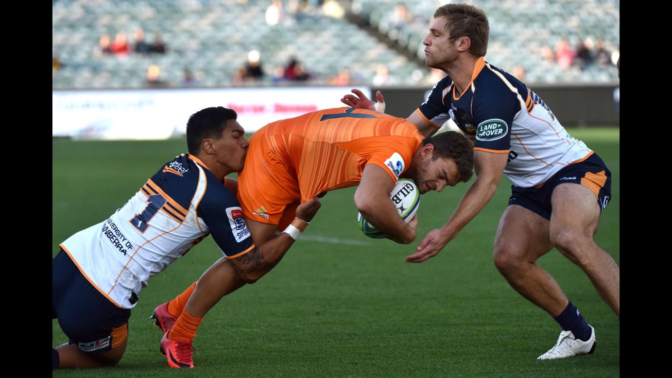 Emiliano Boffelli, a rugby player for the Jaguares, is tackled by the Brumbies' Chance Peni, left, and Kyle Godwin during a Super Rugby match in Canberra, Australia, on Sunday, April 22.