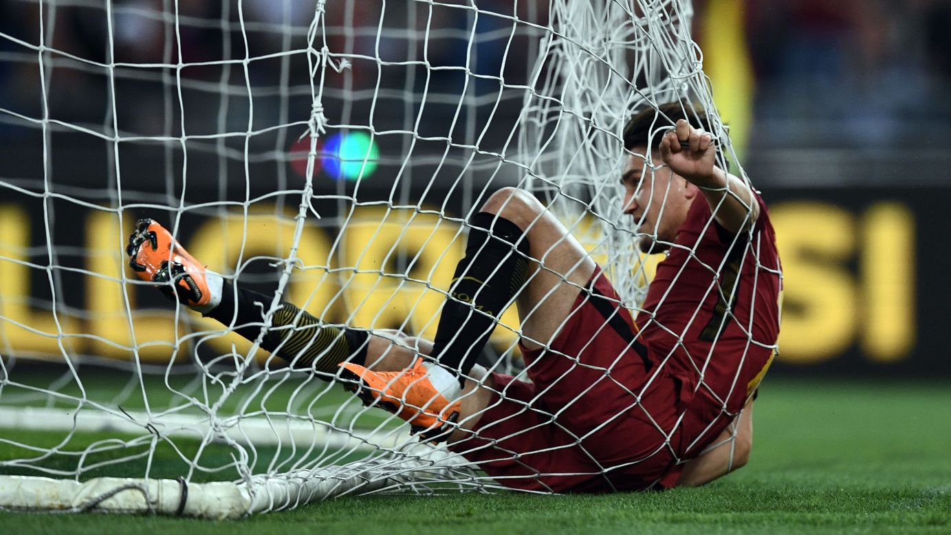 Roma's Cengiz Under falls into the net after scoring a goal against Genoa during an Italian league match on Wednesday, April 18. Roma won the match 2-1.