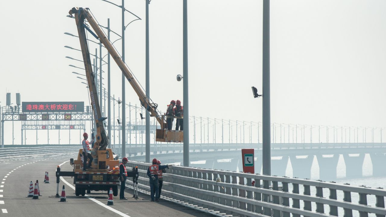 Construction workers put the finishing touches to a section of the Hong Kong-Zhuhai-Macau Bridge in Zhuhai.