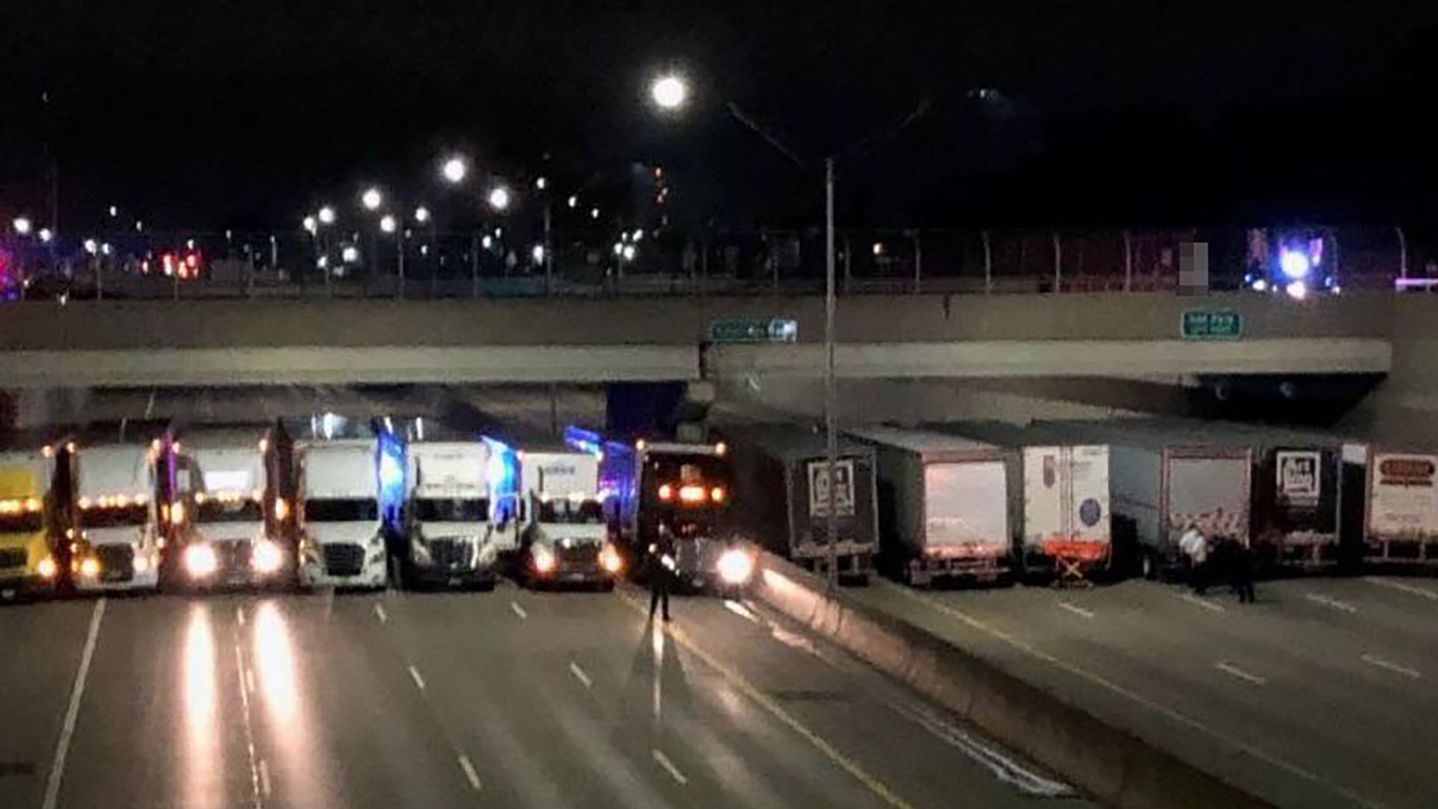 Detroit truckers line up under a freeway overpass to help a suicidal man.