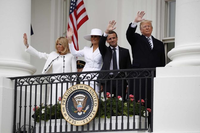 The Trumps and the Macrons wave from the balcony of the White House during an arrival ceremony on April 24.