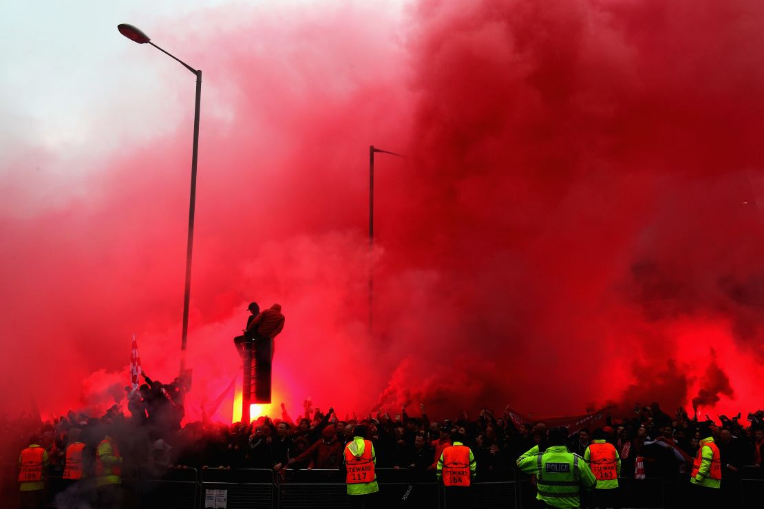 Liverpool fans welcome the team bus to Anfield before the game.