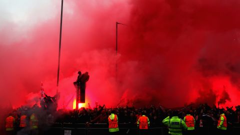 Liverpool fans welcome the team bus to Anfield before the game.