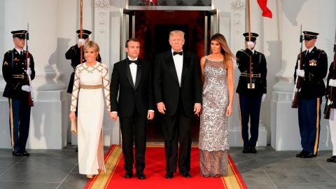 The Trumps pose with French President Emmanuel Macron and his wife Brigitte before Tuesday's dinner.