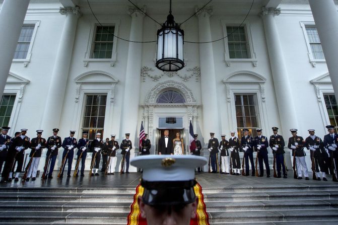 Trump and the first lady wait to greet the Macrons as they arrive for the state dinner.