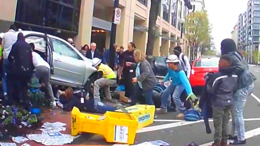 people pinned under car