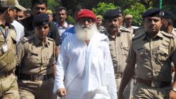 (FILES) In this file photo taken on October 14, 2013 Indian spiritual guru Asaram Bapu (C), accused of sexually assaulting a minor, is escorted by Gujarat state police in Jodhpur.An Indian guru with millions of followers is in court in Jodhpur on April 25, 2018 accused of raping a teenage devotee on the pretext of ridding her of evil spirits. / AFP PHOTO / --/AFP/Getty Images