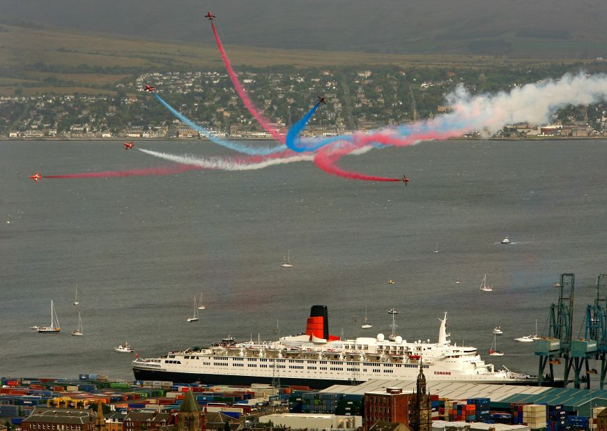 The Red Arrows fly past the QE2 as it sits berthed at Greenock, Scotland, in 2007. It was the 40th anniversary of the ship, and just before her final trip to Dubai. 