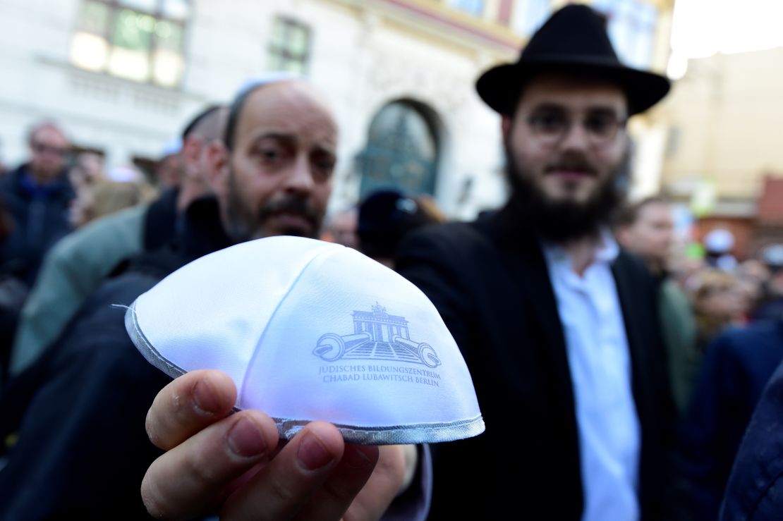 A man shows a kippa during the rally in Berlin.