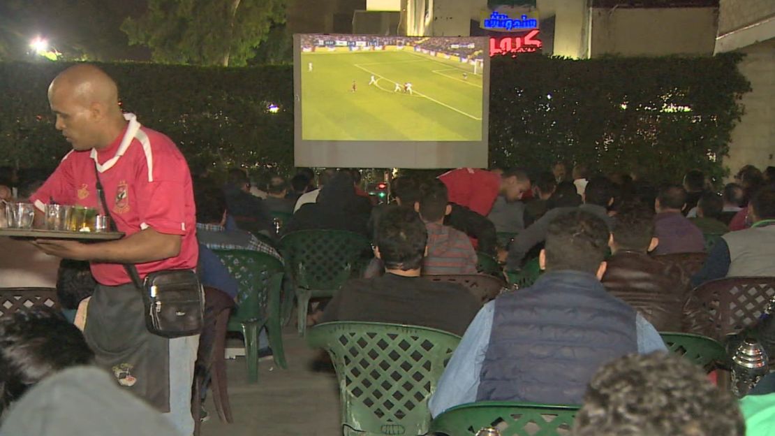 The café is full of people watching Liverpool in the Champions League.