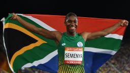 South Africa's Caster Semenya celebrates with flag after winning the athletics women's 800m final during the 2018 Gold Coast Commonwealth Games at the Carrara Stadium on the Gold Coast on April 13, 2018. / AFP PHOTO / SAEED KHAN        (Photo credit should read SAEED KHAN/AFP/Getty Images)