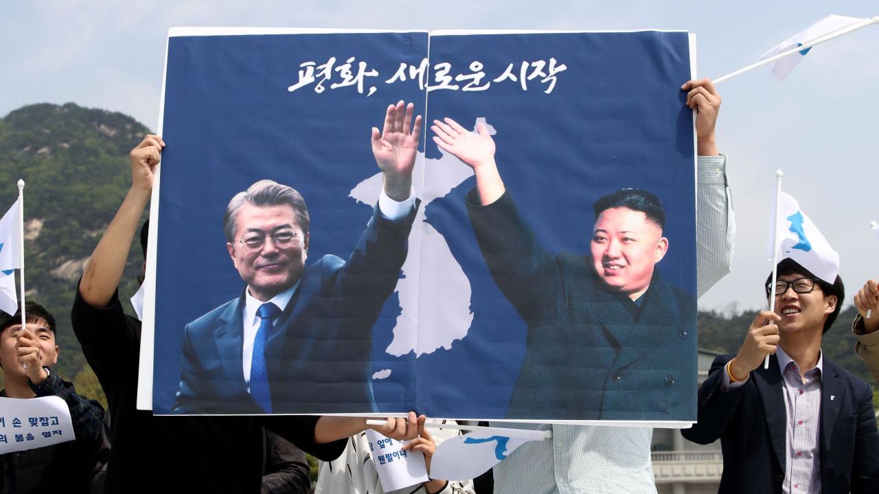 South Koreans hold up placards during a rally welcoming the planned Inter Korean Summit in front of Presidential Blue House on April 26.