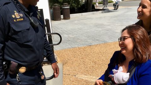 Democratic Sen. Tammy Duckworth of Illinois holds two United States Capitol Police baby stickers that were given to her for Take Your Child to Work Day.