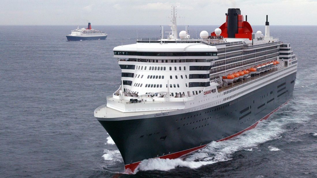 The QE2 (background) alongside The Queen Mary II sail into the English Channel in 2004. The QM2 took over the QE2's transatlantic responsibilities as the world's largest and most expensive liner at the time.