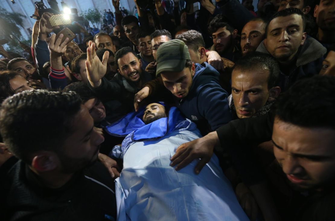 Mourners carry the body of journalist Ahmad Abu Hussein in Beit Lahia on Wednesday.