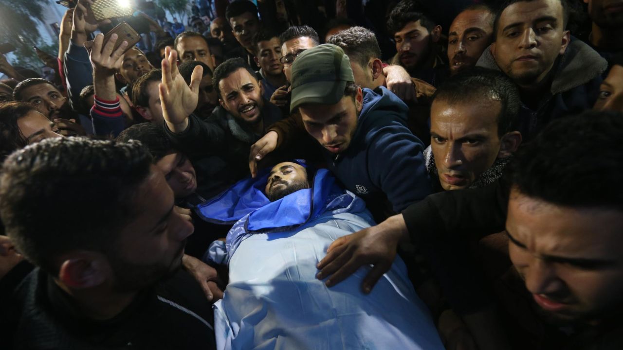 Mourners carry the body of journalist Ahmad Abu Hussein in Beit Lahia on Wednesday.