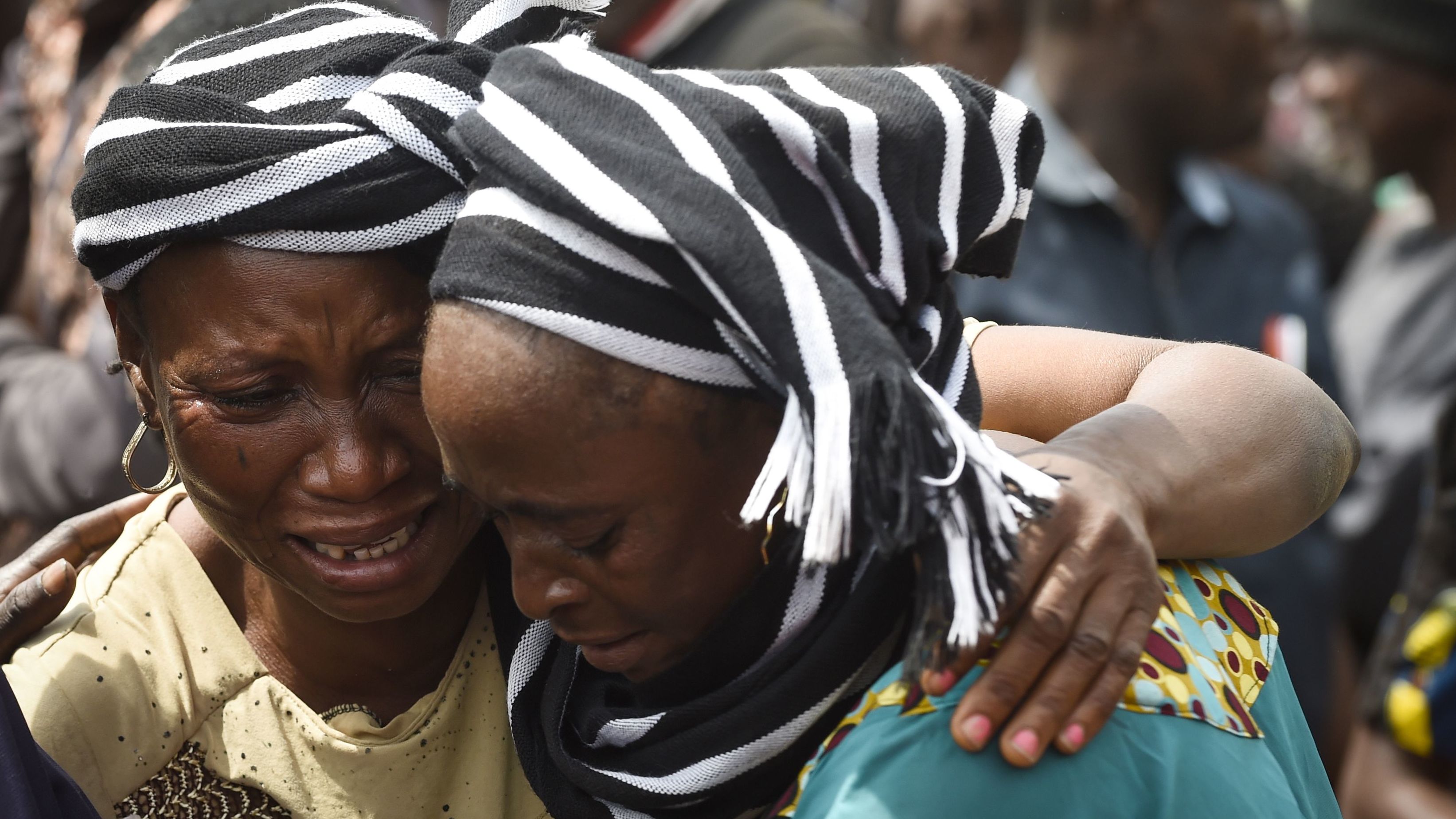A crying woman consoles another one who lost her husband during clashes between cattle herders and farmers, on January 11, 2018. 
