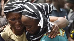 A woman cries while trying to console a woman who lost her husband during the funeral service for people killed during clashes between cattle herders and farmers, on January 11, 2018, in Ibrahim Babangida Square in the Benue state capital Makurdi.
Violence between the mainly Muslim Fulani herdsmen and Christian farmers has claimed thousands of lives across Nigeria's central states over the past few decades. The conflict is being driven by an increasing need for resources -- primarily land and water -- and is often exacerbated by ethnic and sectarian grievances.

 / AFP PHOTO / PIUS UTOMI EKPEI        (Photo credit should read PIUS UTOMI EKPEI/AFP/Getty Images)