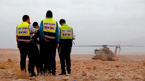 Rescue service personnel stand by Thursday during a search for youths in southern Israel.