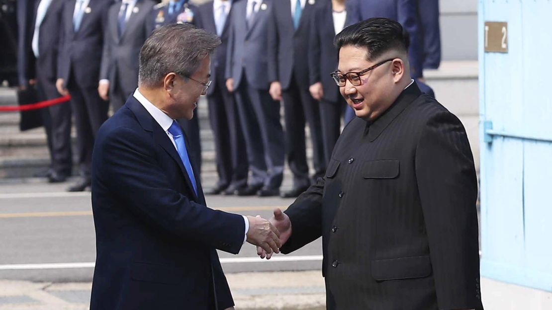North Korean leader Kim Jong Un, right, shakes hands with South Korean President Moon Jae-in Friday.