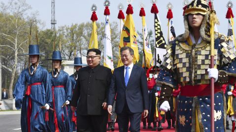 North Korean leader Kim Jong Un, left, and South Korean President Moon Jae-in walk together at the border village of Panmunjom Friday.