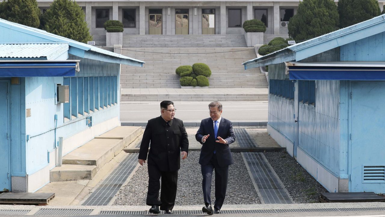 North Korean leader Kim Jong Un, left, listens to South Korean President Moon Jae-in while walking together at the Panmunjom in the Demilitarized Zone Friday, April 27, 2018. Kim made history Friday by crossing over the world's most heavily armed border to greet his rival, Moon, for talks on North Korea's nuclear weapons. (Korea Summit Press Pool via AP)