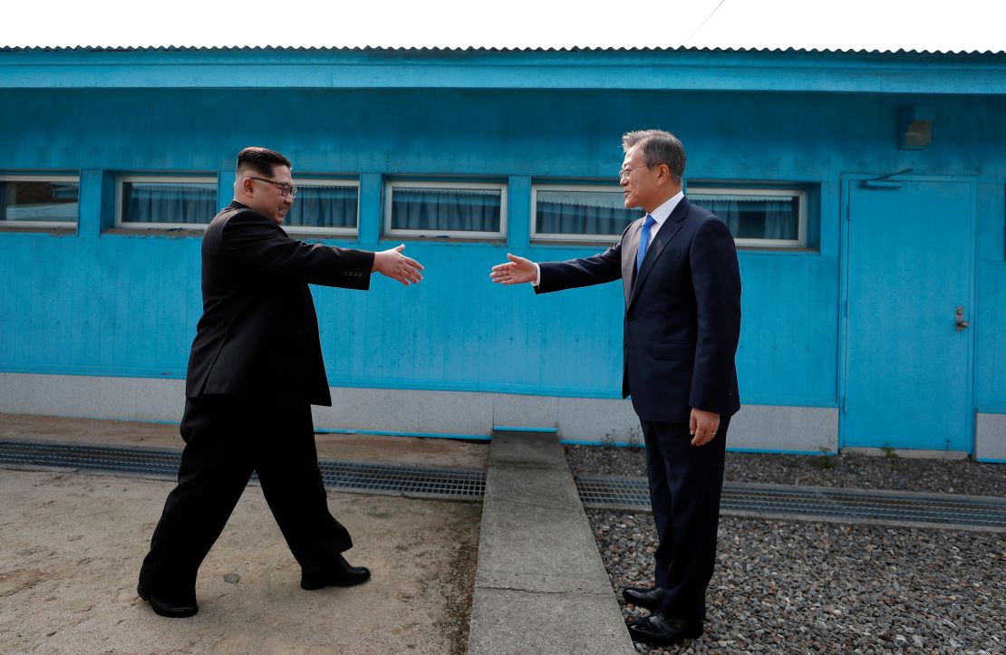 North Korean Leader Kim Jong Un (left) and South Korean President Moon Jae-in (right) shake hands over the military demarcation line that divides the demilitarized zone upon meeting for the inter-Korean Summit on Friday.