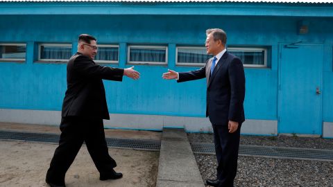 North Korean Leader Kim Jong Un (left) and South Korean President Moon Jae-in (right) shake hands over the military demarcation line that divides the demilitarized zone upon meeting for the inter-Korean Summit on Friday.