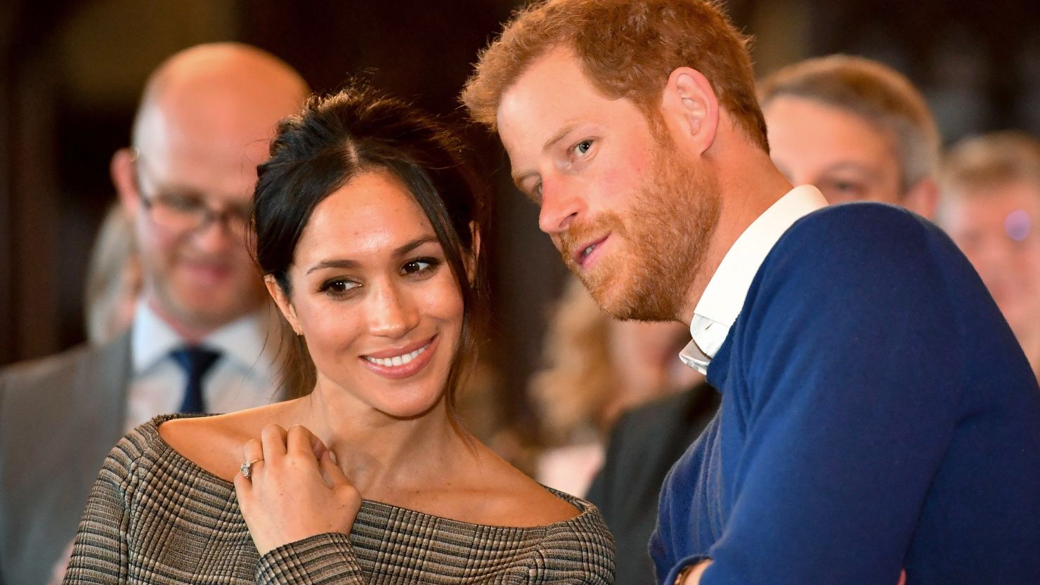 Prince Harry whispers to Meghan Markle as they watch a dance performance in Cardiff, Wales, in January.